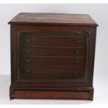 Victorian mahogany collectors cabinet, the arched glazed door opening to reveal six drawers with