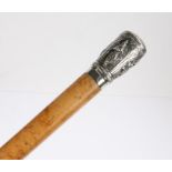 Indian white metal and Malacca walking stick, the cap embossed with depictions of deities 93cm