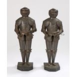 Pair of miniature plate metal suits of armour, on shaped plinth bases, 39cm high (2)