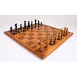 Chess set and board, the chess pieces in ebonised and natural colour, the board in stain wood and