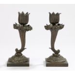 Pair of Regency bronze cornucopia candlesticks, with a flower head above cornucopia above the lappet