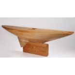 Substantial pond yacht hull, on a wooden plinth base, 134.5cm wide