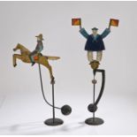 Two 20th Century painted sailor and horse with rider balance figures, raised on stand and pendulum