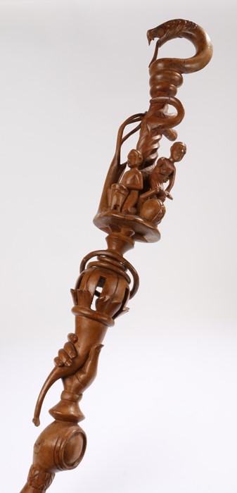 African carved walking stick, with a coiled snake above figure playing musical instruments and a