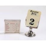 Two silver mounted desk calendars, the first with ivorine panels above the London 1922 base,