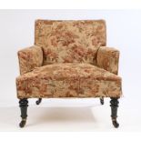 Victorian armchair, with stuff over upholstery above turned legs raised on castors