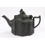 Early 19th Century black basalt teapot, the lid surmounted by a swan above the shaped base and