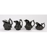 19th Century black basalt pottery milk jugs, to include an example with an eagle surmounting the