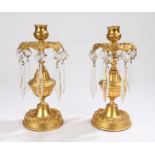 Pair of 19th Century gilt metal lustres, the sconce above arched leaves and glass drops, 22cm