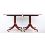 Regency style mahogany twin pillar dining table, the rectangular top with two additional leaves