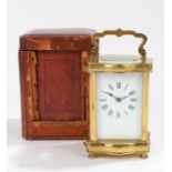 French serpentine cased brass carriage clock, the white enamel dial with Roman numerals, housed in a