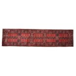 Louis De Poortere runner, the red ground with rectangular patterned centre and lozenge border,