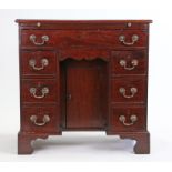 George III mahogany desk, the rectangular top above a brushing slide and six drawers with one