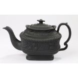 Early 19th Century black basalt Leeds pottery teapot, the flower topped lid with grape and vine