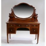 Edwardian mahogany dressing table, with a mirror plate above a serpentine front and drawers to the