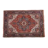 Indo-Persian Heriz design carpet, with lozenge pattern centre and scroll decorated borders, wool