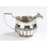 George III silver milk jug, Newcastle marks rubbed, with angular handle and gadrooned rim, the