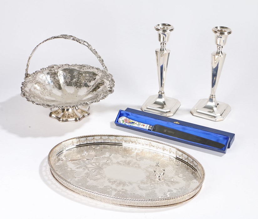 Pair of silver plated candlesticks with tapering sconces, stems and loaded square bases, plated oval