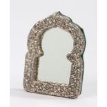 Middle Eastern white metal framed mirror in the form of an arch, with green baize backing, 9.5cm x