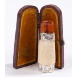 White metal mounted cheroot holder, with amber effect mouthpiece, housed in a velvet lined leather