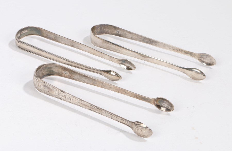 Three pairs of George III and later sugar tongs, to include a bright cut pair, 3.1ozSurface