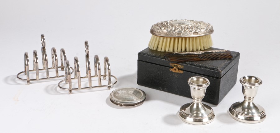 Pair of silver toast racks, Birmingham 1944, together with a pair of silver candlesticks, a silver