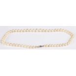 Single strand graduated pearl necklace, with gold, sapphire and diamond set clasp, 44cm long