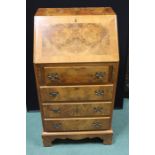 Small walnut veneered bureau, the fall above four long drawers, on bracket feet, 51cm wide