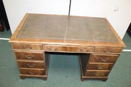George III style mahogany kneehole desk, with a leather inset rectangular top above nine drawers