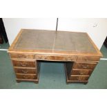 George III style mahogany kneehole desk, with a leather inset rectangular top above nine drawers