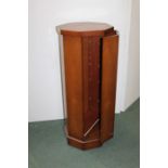 Pedestal cabinet, hexagonal form with a hidden door enclosing a shelved interior, 107cm high