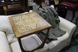 1960's occasional table, set with tiles, together with a Harris Tweed coat, (2)