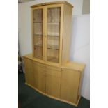 Skovby maple display unit, with two bow front glazed cupboards above a base with two frieze