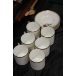 Royal Worcester porcelain coffee cups and saucers, each decorated with different varieties of