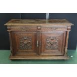 Late 19th Century French oak buffet, with two gadroon carved frieze drawers above two urn, mask