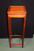 Chinese style hardwood jardiniere stand, the square top raised on square legs united by shaped