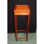 Chinese style hardwood jardiniere stand, the square top raised on square legs united by shaped