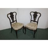 Pair of early 20th Century mahogany side chairs, with a carved foliate back, (2)
