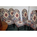 Set of six dining chairs upholstered in an Aztec style material, on ebonised chamfered and turned