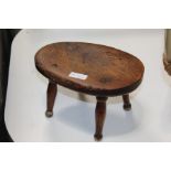 19th Century elm candle stand, with an oval top above turned legs