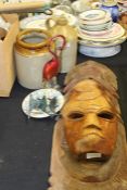 Two carved tribal masks, two stoneware pots, glass bird, cast metal dolphins, Ilfracombe souvenir