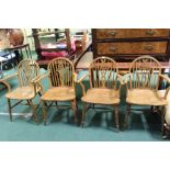 Set of four Windsor wheel-back elbow chairs, with solid dished seats, raised on turned legs and