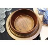 Four treen bowls, two shallow examples and two higher sided, (4)
