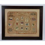 Embroidered panel decorated with cigarette silks depicting flags and regimental crests,