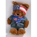 Large teddy bear wearing a blue denim waistcoat and jeans, American flag bandana and headscarf