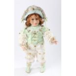 The Palmary Colletion bisque doll "Didi", wearing a green and silk outfit with attached bells,