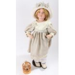 Duck House Heirloom Dolls bisque doll, holding a bird cage and wearing a bonnet and grey dress,