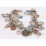 Silver charm bracelet set with thirty-one charms, 55.7g