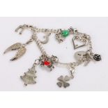 Silver charm bracelet with ten charms, 23.7g