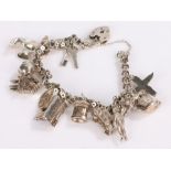 Silver charm bracelet set with thirteen charms, 48.7g
